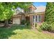 Charming brick and stone home with lush landscaping, mature trees, and inviting front lawn at 107 Sonoma Valley Dr, Cary, NC 27518