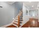 Entry hallway features hardwood floors, wainscoting, and a staircase leading to the upper level at 107 Sonoma Valley Dr, Cary, NC 27518