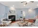 Cozy living room with a fireplace, wood floors, and plenty of natural light at 107 Sonoma Valley Dr, Cary, NC 27518
