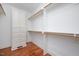 Walk-in closet with custom storage solutions and wood flooring at 107 Sonoma Valley Dr, Cary, NC 27518