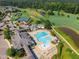 An aerial view of a neighborhood pool and clubhouse located by a golf course at 108 Ribbon Walk Ln, Holly Springs, NC 27540