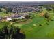 Beautiful aerial view of a community with a lush golf course, swimming pool and tennis courts at 108 Ribbon Walk Ln, Holly Springs, NC 27540