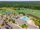 A scenic view from above showcasing a pool, clubhouse, playground, and golf course at 108 Ribbon Walk Ln, Holly Springs, NC 27540