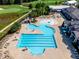Aerial view of community pool, clubhouse, golf course, and surrounding landscape at 108 Ribbon Walk Ln, Holly Springs, NC 27540