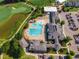 An aerial view of a clubhouse, pool, and golf course in a well maintained community at 108 Ribbon Walk Ln, Holly Springs, NC 27540