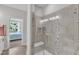 Modern bathroom featuring a glass shower with a built-in seat and decorative tile accent at 108 Ribbon Walk Ln, Holly Springs, NC 27540