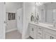 Bright bathroom features double sink vanity with white cabinets and a shower with shower curtain at 108 Ribbon Walk Ln, Holly Springs, NC 27540