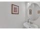 Clean and simple powder room featuring a pedestal sink and decorative wall art at 108 Ribbon Walk Ln, Holly Springs, NC 27540