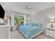 Bright bedroom with large window and ceiling fan at 108 Ribbon Walk Ln, Holly Springs, NC 27540