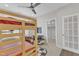 Bedroom features bunk bed, ceiling fan, door to a walk-in closet, and fun decor at 108 Ribbon Walk Ln, Holly Springs, NC 27540