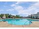 Gathering friendly outdoor pool with a slide and zero entry point, surrounded by umbrellas and lounge chairs at 108 Ribbon Walk Ln, Holly Springs, NC 27540