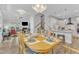 Bright and airy dining room with wood floors, dining table and chairs, with a kitchen view at 108 Ribbon Walk Ln, Holly Springs, NC 27540