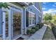 Charming front entrance with decorative glass door, stone accents, and manicured landscaping provides inviting curb appeal at 108 Ribbon Walk Ln, Holly Springs, NC 27540
