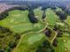 Aerial shot of an impeccably maintained golf course, showing its lush greens at 108 Ribbon Walk Ln, Holly Springs, NC 27540