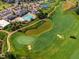 Birds eye view of the community golf course with a water hazard and a green at 108 Ribbon Walk Ln, Holly Springs, NC 27540