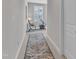 Hallway leads to a bedroom with exercise bike and bench positioned in front of the shuttered windows at 108 Ribbon Walk Ln, Holly Springs, NC 27540