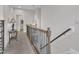 Upstairs hallway with a decorative table and lamp adjacent to the staircase at 108 Ribbon Walk Ln, Holly Springs, NC 27540