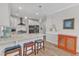 Bright kitchen with quartz countertops, stainless steel appliances, and stylish pendant lighting at 108 Ribbon Walk Ln, Holly Springs, NC 27540