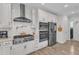 Gourmet kitchen with stainless appliances, pot filler and white cabinets at 108 Ribbon Walk Ln, Holly Springs, NC 27540