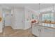 Bright eat-in kitchen with white cabinets, stainless steel appliances and hardwood floors at 108 Ribbon Walk Ln, Holly Springs, NC 27540