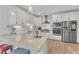 Modern kitchen with white cabinets, stainless steel appliances, and a center island with barstool seating at 108 Ribbon Walk Ln, Holly Springs, NC 27540