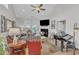 Cozy living room with high ceilings, a fireplace, and French doors leading to the outside at 108 Ribbon Walk Ln, Holly Springs, NC 27540