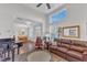 Bright and airy living room with large windows, hardwood floors, and a comfortable leather sofa at 108 Ribbon Walk Ln, Holly Springs, NC 27540