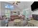 Bright living room with vaulted ceilings, a fireplace, and double glass doors at 108 Ribbon Walk Ln, Holly Springs, NC 27540