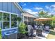 Outdoor patio seating area features a grill and an umbrella-covered table and chairs at 108 Ribbon Walk Ln, Holly Springs, NC 27540
