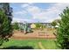 Community playground with slides, swing set, and green play structures on a sunny day at 108 Ribbon Walk Ln, Holly Springs, NC 27540