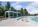 Resort-style pool featuring sun loungers in a shallow area and shaded seating at 108 Ribbon Walk Ln, Holly Springs, NC 27540