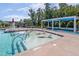 Zero-entry pool area with lounge chairs and a shaded pavilion for relaxing by the pool at 108 Ribbon Walk Ln, Holly Springs, NC 27540