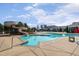Beautiful swimming pool with a slide and lounge chairs surrounded by a concrete patio at 108 Ribbon Walk Ln, Holly Springs, NC 27540