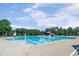 Large community pool featuring swimming lanes, slide, and plenty of open space for summer fun and relaxation at 108 Ribbon Walk Ln, Holly Springs, NC 27540