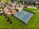 Aerial view of community tennis courts alongside a playground and parking lot at 108 Ribbon Walk Ln, Holly Springs, NC 27540