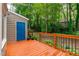 Inviting back deck with a vibrant blue door, offering a serene outdoor space surrounded by lush greenery at 112 Barcelona Ct, Cary, NC 27513