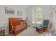 Bright Bedroom with a large window, rocker, and a wooden crib at 112 Barcelona Ct, Cary, NC 27513