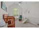 Neutral Bedroom with vaulted ceiling, arched window, rocker, and play set at 112 Barcelona Ct, Cary, NC 27513