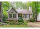 Charming home featuring a landscaped front yard, a welcoming blue door and a cozy, quaint curb appeal at 112 Barcelona Ct, Cary, NC 27513