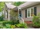 Front of the house with a quaint blue front door and a neatly landscaped garden area at 112 Barcelona Ct, Cary, NC 27513