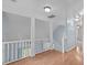 Hallway featuring a white banister and a hardwood floor at 112 Barcelona Ct, Cary, NC 27513