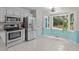 Well-lit kitchen features stainless steel appliances and a large window overlooking the backyard at 112 Barcelona Ct, Cary, NC 27513