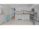 Well-lit kitchen with white cabinetry, stainless steel appliances, and granite countertops at 112 Barcelona Ct, Cary, NC 27513