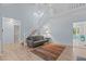 Bright living room featuring a gray couch and a staircase leading to the second floor at 112 Barcelona Ct, Cary, NC 27513