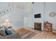 Living room featuring high ceilings, fireplace, and stairs to a second-floor landing at 112 Barcelona Ct, Cary, NC 27513