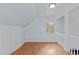 Loft with hardwood flooring, neutral blue walls, and a window at 112 Barcelona Ct, Cary, NC 27513