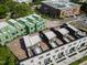 Aerial view of modern townhomes with rooftop patios and green construction next door at 1311 Chamblee Hill Ct, Raleigh, NC 27608