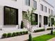 Modern brick townhomes with black-trimmed windows, sidewalk, and manicured landscaping at 1311 Chamblee Hill Ct, Raleigh, NC 27608