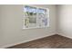 Bright bedroom with hardwood floors, a window with a view of the outdoors, and neutral walls at 137 Pisgah St, Sanford, NC 27330
