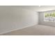 Spacious bedroom with neutral carpeting and a bright window; ample natural light at 137 Pisgah St, Sanford, NC 27330
